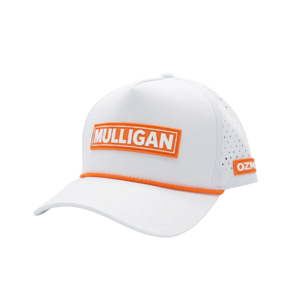 A white golf cap with bright orange trim and a prominent orange rectangular patch on the front that reads 'MULLIGAN' in white. The side panel has perforated holes, and a small orange patch on the back edge shows 'OZM'.