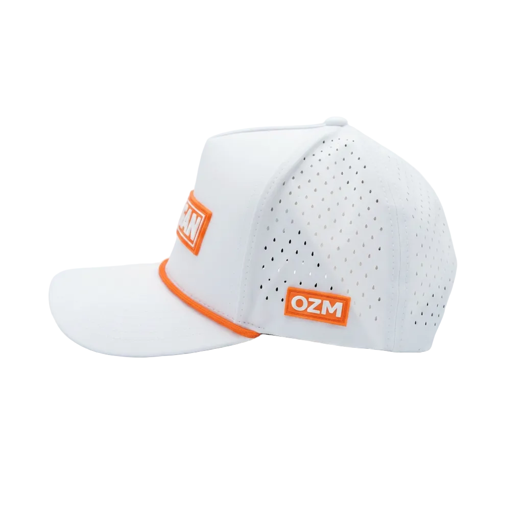 A white perforated golf cap with bright orange embroidered patches and a matching orange trim on the brim, shown on a clean white studio background.